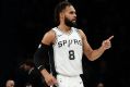 San Antonio Spurs' Patty Mills (8) reacts after making a three point basket during the second half of an NBA basketball ...