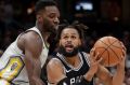 San Antonio Spurs' Patty Mills, center, from Australia, drives between Cleveland Cavaliers' Jeff Green, left, and Kyle ...