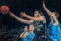 Quick hands: Melbourne captain Chris Goulding dishes off a pass from under the basket in the first semi-final against ...