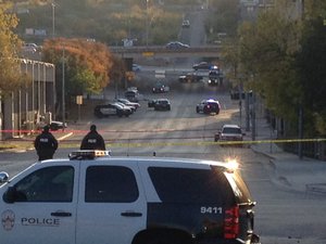 Police tape marks off the scene after authorities shot and killed a man who they say opened fire on the Mexican Consulate, police headquarters and other downtown buildings early Friday, Nov. 28, 2014, in Austin, Texas.