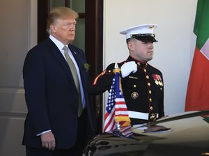 President Donald Trump stands outside the West Wing of the White House, Thursday, March 15, 2018, in Washington, as Irish Prime Minister Leo Varadkar arrives.