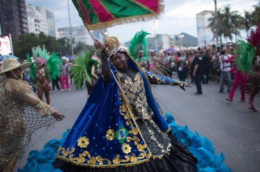 A member of a samba school parades along Copacabana Beach in Rio de Janeiro, Brazil. Musicians and members from Rio de ...