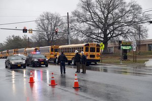 Law enforcement officers stand near the entrance to Great Mills High School, the scene of a shooting, Tuesday, March 20, 2018, in Great Mills.