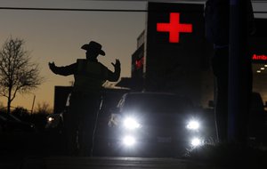 People evacuate as emergency vehicles stage near the site of another explosion, Tuesday, March 20, 2018, in Austin, Texas.