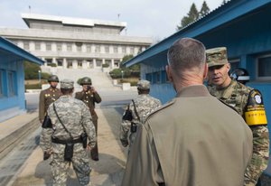 File - U.S. Marine Corps Gen. Joseph F. Dunford Jr., right foreground, chairman of the Joint Chiefs of Staff, talks with U.S. Army Col. James Minnich, secretary of the U.N. Command Military Armistice Commission, during his visit to the Demilitarized Zone in South Korea, Nov. 2, 2015.