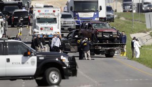 Officials remove from the scene a car of the suspect in a series of bombing attacks in Austin blew himself up early Wednesday as authorities closed in, Wednesday, March 21, 2018, in Round Rock, Texas.