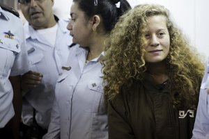 Ahed Tamimi is brought to a courtroom inside Ofer military prison near Jerusalem, Thursday, Dec. 28, 2017.