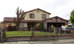 People gather outside the home, Wednesday March 21, 2018, where Stephon Alonzo Clark, 22, was shot and killed by a pair of Sacramento Police officers in Sacramento, Calif.