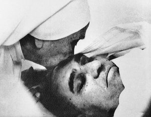 In this March 23, 1980, file photo, a nun plants a kiss on the forehead of slain Archbishop Oscar Arnulfo Romero of El Salvador at the Hospital of Divine Providence.