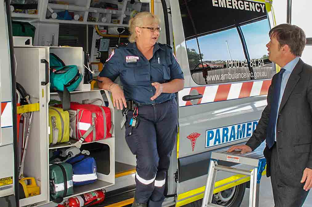 Talking to paramedic at local ambulance station