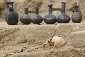 The remains of a child sit next to ceramic pieces at the Jotoro archaeological complex in Lambayeque, Peru, Friday, May 21, 2010.