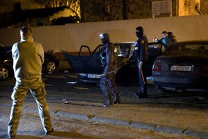 French Police officers search a car during a raid in Carcassonne following an incident in Trebes, southern France, Friday March 23, 2018.