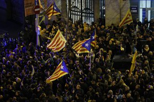 Large crowds, some with Catalan independence flags, gather in Barcelona, Spain, Friday, March 23, 2018 to protest the jailing of Catalan politicians.