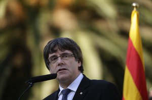 Catalan regional President Carles Puigdemont addresses to the media after a ceremony commemorating the 77th anniversary of the death of Catalan leader Lluis Companys at the Montjuic Cemetery in Barcelona, Spain, Sunday, Oct. 15, 2017.