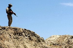  U.S. Marine Corps Cpl. Joe Gazzam, a machine gunner with the Kilo Company, 3rd Battalion, 3rd Marine Regiment provides security during a vehicle checkpoint in the vicinity of Methar Lam, Afghanistan, May 20 2005. 3rd Battalion. The 3rd Marines is conduct