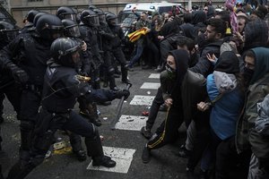 Catalan Mossos d'Esquadra regional police officers clash with pro-independence supporters trying to reach the Spanish government office in Barcelona, Spain