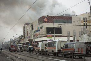 Smoke rises above a multi-story shopping center in the Siberian city of Kemerovo, about 3,000 kilometers (1,900 miles) east of Moscow, Russia