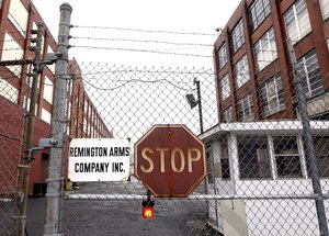 In this Jan. 17, 2013, file photo, a sign is placed in front of the Remington Arms Company in Ilion, N.Y.