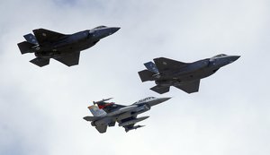 FILE - This Sept. 2, 2015 file photo shows an F-16, below, escorting two F-35 jets, above, after arriving the latter arrived at Hill Air Force Base in Utah.