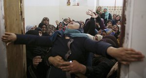 Relatives mourn when they carry the body of Hamdan Abu Amsha, 23, during his funeral at his family house in Beit Hanoun, Gaza Strip, Saturday, March 31, 2018.