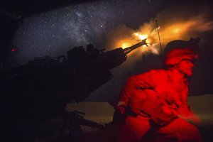 File - A Marine fires an M777A2 howitzer in the early morning in Syria, June 3, 2017. Marines were conducting 24-hour all-weather fire support for the coalition's local partners, the Syrian Democratic Forces