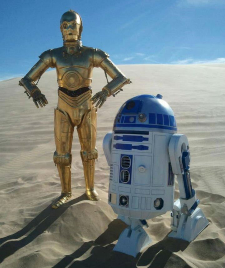 C-3PO and R2-D2 in a sandy desert with blue skies