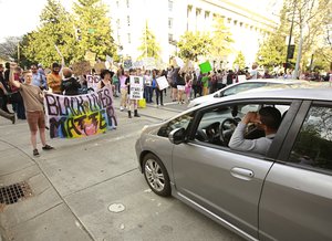 Protestors block an intersection in downtown Sacramento, Calif., after the funeral for police shooting victim Stephon Clark Thursday, March 29, 2018.