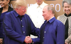 Donald Trump and Vladimir Putin shake hands during photo ceremony of APEC economic leaders, Danang, Vietnam