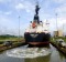 A tanker passing through Miraflores lock, guided by electronic "mules".