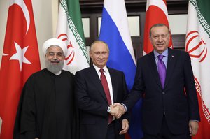 Turkey's President Recep Tayyip Erdogan, right, Russia's President Vladimir Putin, center, and Iran's President Hassan Rouhani pose for the media members in Sochi, Russia, Wednesday, Nov. 22. 2017.