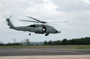 A helicopter crew assigned to Helicopter Anti-Submarine Squadron (HS) 7, departs Naval Air Station Jacksonville.