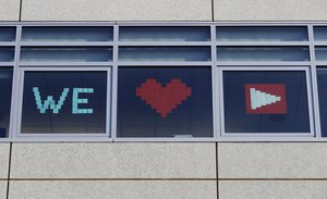 A sign for YouTube is displayed from windows at a Walmart corporate office in San Bruno, Calif., Tuesday, April 3, 2018.