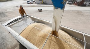 Terry Morrison of Earlham, Iowa, watches as soybeans are loaded into his trailer at the Heartland Co-op, Thursday, April 5, 2018, in Redfield, Iowa.