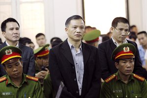 Prominent human rights lawyer Nguyen Van Dai, center, stands trial in Hanoi, Vietnam, Thursday, April 5, 2018.