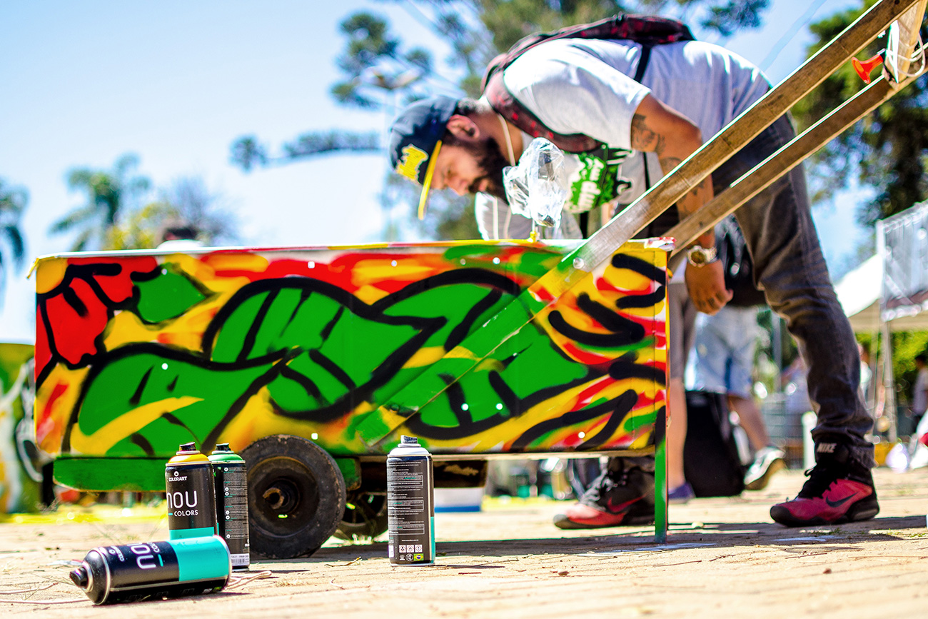 A man spray-painting a cart