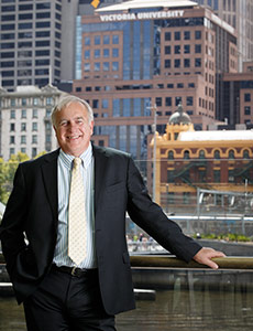 Alan Kohler standing in front of the City Flinders campus building