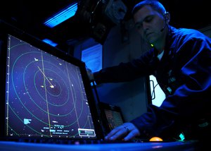 Air Traffic Controller 1st Class Matthew Cuppernoll, from Flint, Mich., searches for radar signatures during flight operations aboard the aircraft carrier USS Ronald Reagan (CVN 76).