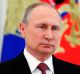 Russian President Vladimir Putin speaks during a live televised speech in Moscow, Russia, Friday, March 23, 2018. ...