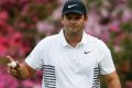 Patrick Reed reacts after making a birdie putt on the 13th hole during the second round at the Masters golf tournament ...