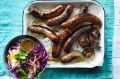 Barbecued sausages with red cabbage and mustard salad.