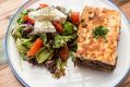 Vegan moussaka and Greek salad with vegan feta.