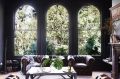 The home is on a sloping block, so the living room looks into the treetops through arched windows that Kali had ...