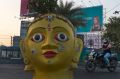 A motorist rides past a hoarding of US President daughter Ivanka Trump as a statue is erected at the entrance of HITECH ...