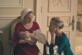 Offred the handmaid, played by Elizabeth Moss, and commander's wife Serena Joy, played by Yvonne Strahovski. 