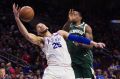 Ben Simmons tangles with the Bucks' Eric Bledsoe in their NBA match.