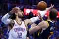 Thunder centre Steven Adams (right) gets into the contest with Utah's Joe Ingles.