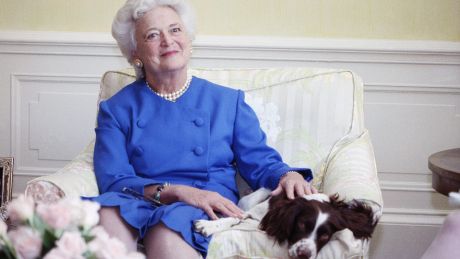 Barbara Bush poses with her dog Millie in Washington, 1990.
