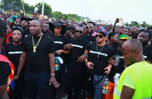 In this photo taken on Saturday, May 16, 2015, Ghana actress Yvonne Nelson, third left, walks with others as they protest against power cuts in Accra, Ghana.