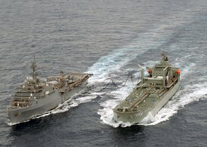 Royal Australian Navy ship HMAS Sirius (OR-266) and amphibious transport dock USS Juneau (LPD 10) conducts a replenishment at sea (RAS).