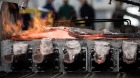 Flames rise from molten aluminium in a molding unit at a processing plant in Hungary.